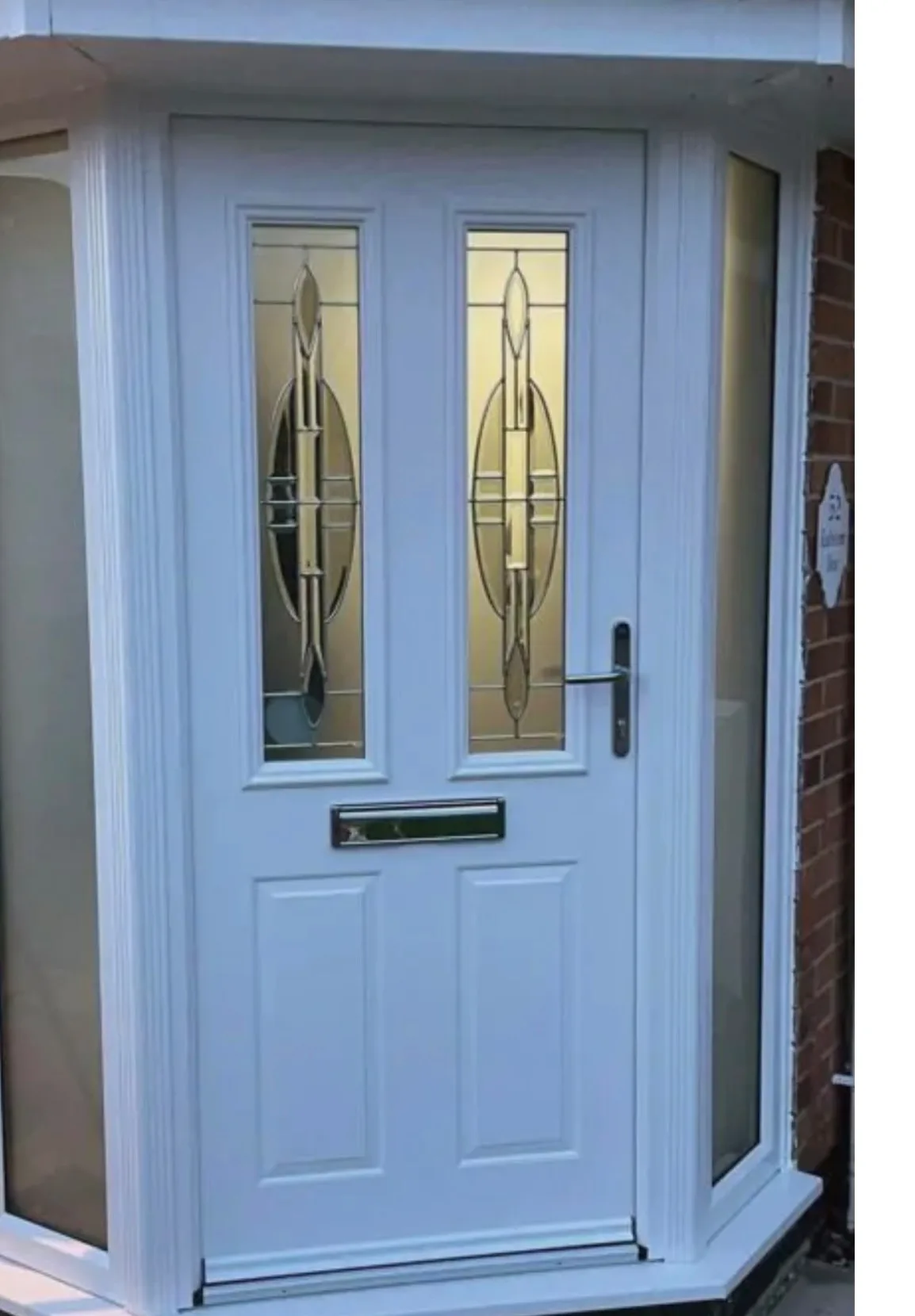 White UPVC entrance door with decorative glazing